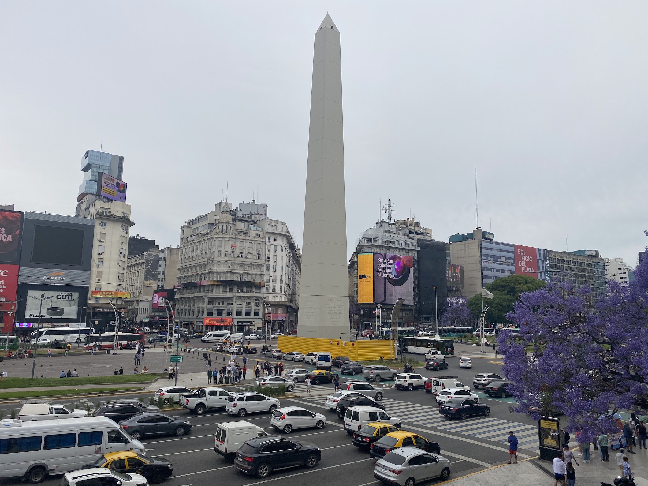 Busy city with a lot of cars and big white obelist